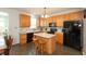 Kitchen includes a center island with bar stool seating, classic cabinets, and modern appliances at 2093 Autumn Faith Way, Avon, IN 46123