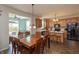 Open-concept kitchen and dining area featuring wood cabinets, modern appliances, and ample seating at 2093 Autumn Faith Way, Avon, IN 46123