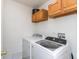 Bright laundry room with washer, dryer, storage cabinets, and room for folding at 2093 Autumn Faith Way, Avon, IN 46123