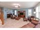Inviting living room with comfortable leather seating, a cozy fireplace, and plenty of natural light from large windows at 2093 Autumn Faith Way, Avon, IN 46123