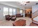 Bright and airy living room featuring a staircase and views into the kitchen, perfect for entertaining at 2093 Autumn Faith Way, Avon, IN 46123