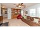 Inviting living room with a built-in bookcase, comfortable seating, and ample natural light from the window at 2093 Autumn Faith Way, Avon, IN 46123
