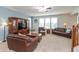 Living room features plush seating, natural light, and ample space for relaxation or entertaining at 2093 Autumn Faith Way, Avon, IN 46123