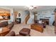 Spacious living room with comfortable leather furniture, a staircase, and access to the kitchen at 2093 Autumn Faith Way, Avon, IN 46123