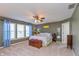 Spacious main bedroom with natural light, ceiling fan, and neutral colors for a relaxing retreat at 2093 Autumn Faith Way, Avon, IN 46123