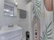 Compact bathroom with a modern vanity, shower and decorative curtain at 213 N Walnut St, Edinburgh, IN 46124