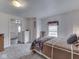 Cozy bedroom featuring neutral walls, carpet flooring, and a door that leads to an adjacent room at 213 N Walnut St, Edinburgh, IN 46124
