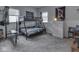 Bedroom featuring carpet flooring, neutral walls, two windows, and a metal bunk bed at 213 N Walnut St, Edinburgh, IN 46124
