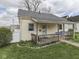 Charming home featuring a quaint front porch, manicured lawn, and inviting curb appeal on a partially cloudy day at 213 N Walnut St, Edinburgh, IN 46124