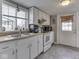Functional kitchen with white appliances, ample counter space, and a convenient back door at 213 N Walnut St, Edinburgh, IN 46124