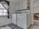 Functional laundry room featuring a washer and dryer, wall cabinets, and vinyl flooring at 213 N Walnut St, Edinburgh, IN 46124