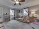 Comfortable living room with neutral tones, a ceiling fan, plush carpeting, and ample natural light at 213 N Walnut St, Edinburgh, IN 46124