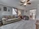 Spacious living room showcasing comfortable furniture, soft carpeting, and an open layout with an adjacent dining area at 213 N Walnut St, Edinburgh, IN 46124
