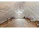 Unfinished attic with wooden floorboards offering expansion potential at 217 Eikenberry St, Greenfield, IN 46140