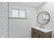 Bathroom sink vanity with modern faucet and round mirror at 217 Eikenberry St, Greenfield, IN 46140