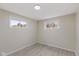 Bright bedroom featuring two windows and light wood-look flooring at 217 Eikenberry St, Greenfield, IN 46140