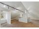 Large bonus room with track lighting and neutral carpet at 217 Eikenberry St, Greenfield, IN 46140