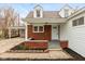 Inviting front porch with brick accents and a covered entryway at 217 Eikenberry St, Greenfield, IN 46140