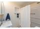 Well-lit bathroom featuring a shower with a white curtain, and neutral tile at 218 Miami Dr, Noblesville, IN 46062