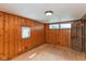 Bright bedroom with hardwood floors and wood paneling provides a clean, functional, and naturally appealing space at 218 Miami Dr, Noblesville, IN 46062