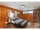 Cozy bedroom featuring wood paneling, natural light, and neutral decor, creating a warm and inviting space at 218 Miami Dr, Noblesville, IN 46062