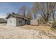 Quaint home featuring a well-maintained yard, outdoor seating, and a fire pit, set against a backdrop of mature trees at 218 Miami Dr, Noblesville, IN 46062