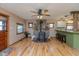 Inviting living room with hardwood floors, a stone fireplace, and a view of the breakfast bar at 218 Miami Dr, Noblesville, IN 46062