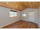 Bright living room with vaulted wood ceiling, multiple windows, and clean, minimalist design at 218 Miami Dr, Noblesville, IN 46062