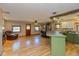 Bright open-concept living room featuring wood floors, a stone fireplace, and a breakfast bar at 218 Miami Dr, Noblesville, IN 46062