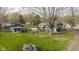 Expansive yard features a cozy guest house, mature trees, and lush green grass at 218 Miami Dr, Noblesville, IN 46062