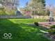 Spacious backyard featuring a lush lawn, deck, and mature trees, creating a private outdoor oasis at 2335 Durham Dr, Indianapolis, IN 46220