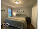 Cozy bedroom featuring wood floor and plenty of sunlight at 2335 Durham Dr, Indianapolis, IN 46220