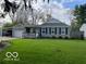 Charming single-story home featuring a manicured lawn, attached carport, and classic curb appeal at 2335 Durham Dr, Indianapolis, IN 46220