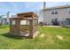 Green backyard features a wooden playset, patio, and deck, perfect for outdoor enjoyment at 270 Lazy Hollow Dr, Brownsburg, IN 46112