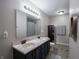 Bathroom features double vanity, marble countertop, framed mirror, and tiled flooring at 270 Lazy Hollow Dr, Brownsburg, IN 46112