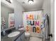 Cozy bathroom featuring modern vanity and a shower with a colorful Hello Sunshine curtain at 270 Lazy Hollow Dr, Brownsburg, IN 46112