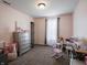 This bedroom is decorated in pink with a small desk, rocker, and dresser at 270 Lazy Hollow Dr, Brownsburg, IN 46112