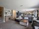 Cozy living room featuring a large sectional sofa, decorative shelves, and easy access to the kitchen at 270 Lazy Hollow Dr, Brownsburg, IN 46112