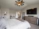 This primary bedroom is spacious and features neutral tones and a large TV at 270 Lazy Hollow Dr, Brownsburg, IN 46112