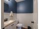 Stylish powder room with navy blue walls and white wainscoting at 270 Lazy Hollow Dr, Brownsburg, IN 46112