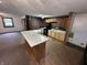 Inviting kitchen featuring a breakfast bar, contrasting brick accent wall, and modern black appliances at 2975 High Rock Dr, Martinsville, IN 46151