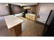 Modern kitchen with black appliances, breakfast bar, wood cabinets and an eye-catching brick accent wall at 2975 High Rock Dr, Martinsville, IN 46151