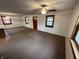 Spacious living room featuring neutral carpeting, a ceiling fan, and natural light from multiple windows at 2975 High Rock Dr, Martinsville, IN 46151