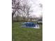 View of backyard area featuring an above ground pool surrounded by a blue tarp at 3101 N Temple Ave, Indianapolis, IN 46218