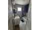 A functional bathroom with a vanity sink, bathtub with shower, and natural lighting at 3101 N Temple Ave, Indianapolis, IN 46218