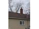 Close up of the house's chimney and brown shingle roof at 3101 N Temple Ave, Indianapolis, IN 46218