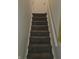 Carpeted stairs with white railing lead to the upper or lower level of the house at 3101 N Temple Ave, Indianapolis, IN 46218
