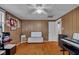 A bedroom with wood floors, a ceiling fan, and a view of the front yard at 3155 W 57Th St, Indianapolis, IN 46228