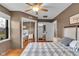 Comfortable bedroom with mirrored closet doors, wood floors, ample natural light, and neutral decor at 3155 W 57Th St, Indianapolis, IN 46228
