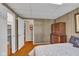 Bedroom featuring wood floors, built-in storage, and an open doorway to an adjacent room at 3155 W 57Th St, Indianapolis, IN 46228